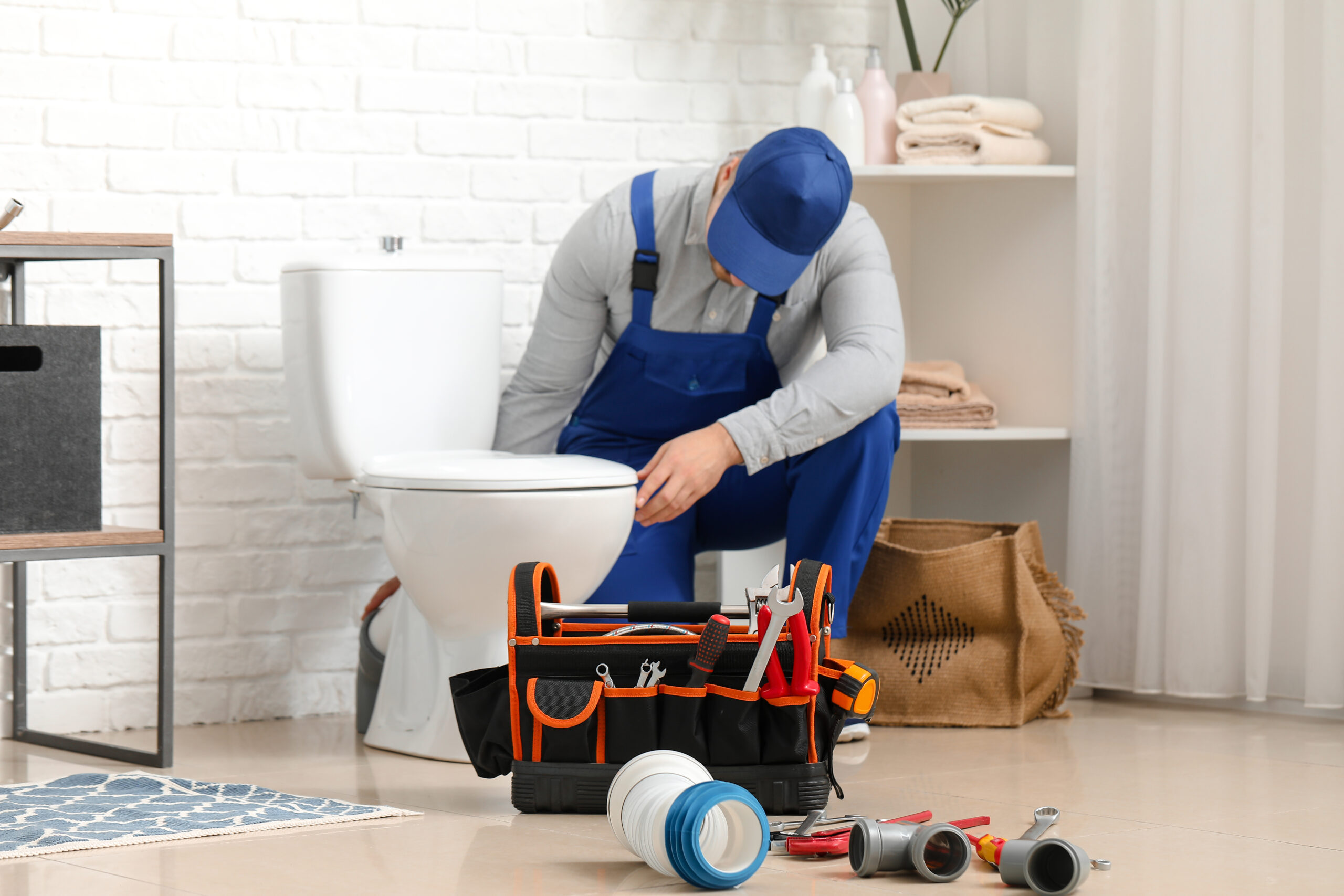 Spokane plumber making toilet repairs