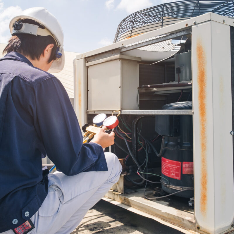 Technician performing commercial Ac maintenance