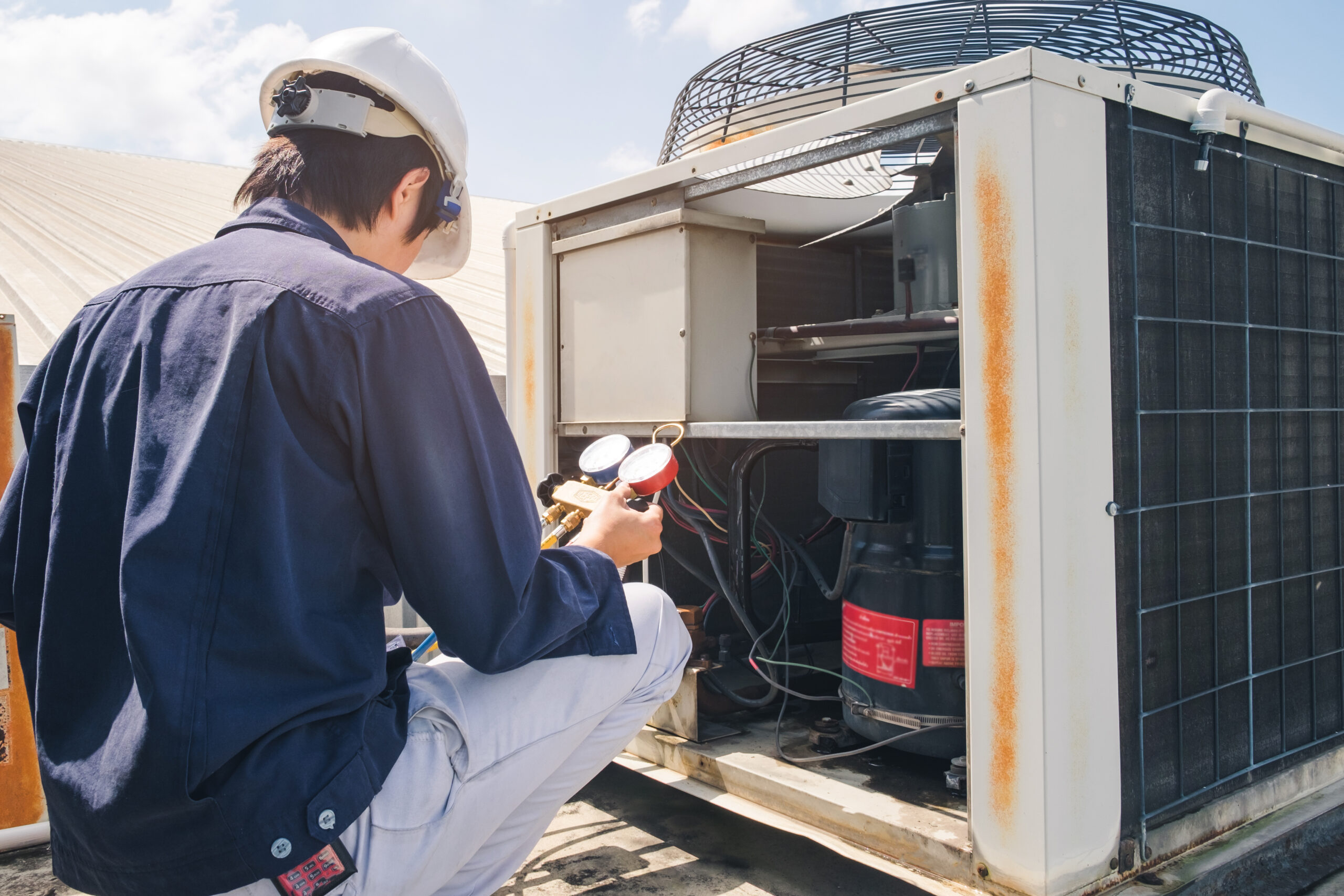 Technician performing commercial Ac maintenance